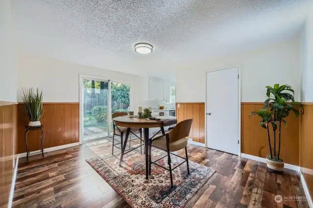 Spacious open, flowing space with original paneling, chair rail and unfettered views of the property's exterior. Pictured is the pantry in this formal dining area