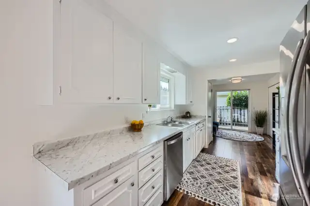 Bright & modern kitchen boasts Frigidaire Stainless Steel appliances, updated hardware, marblesque countertops and, stainless double bowl sink