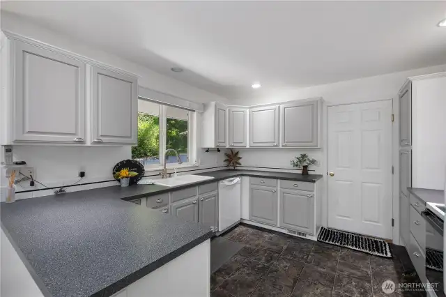 Kitchen is bright and open - lots of storage