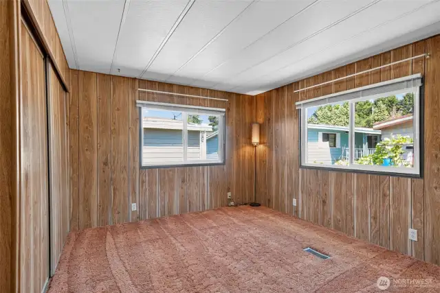 Primary bedroom has two large windows.