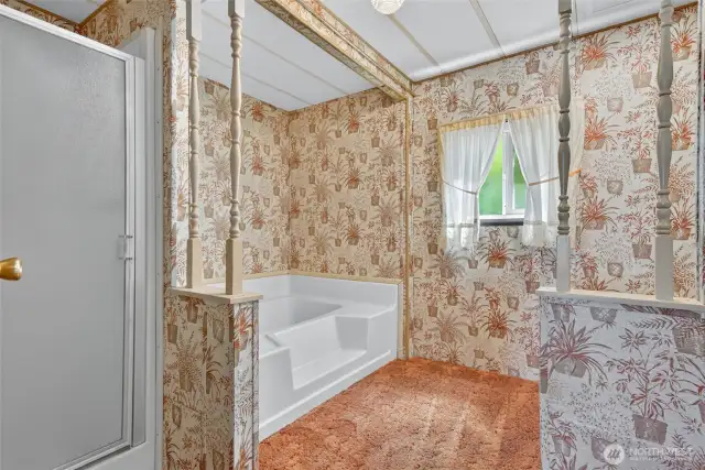 Primary suite has a soaking tub and separate shower.