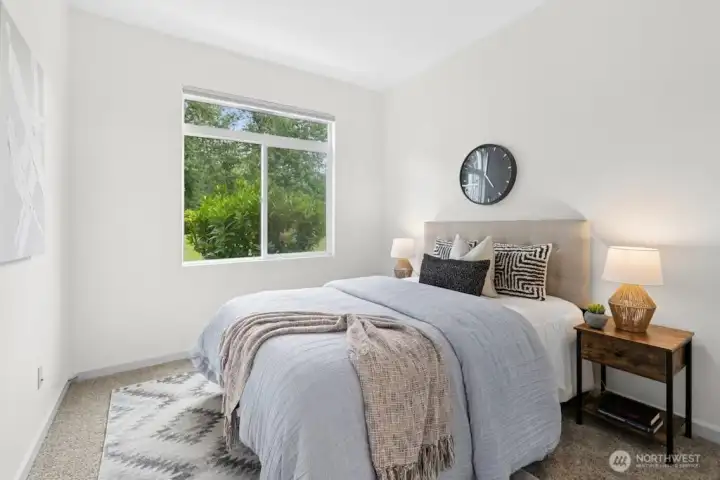 Second bedroom with peaceful greenbelt views, conveniently located across from the full hall bath.
