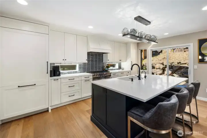 Kitchen with quartz counters, custom soft-close cabitenary, stainless steel appliances and much more.