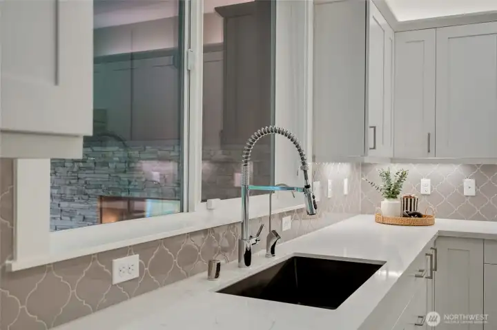 Sleek undermount sink with designer tile backsplash