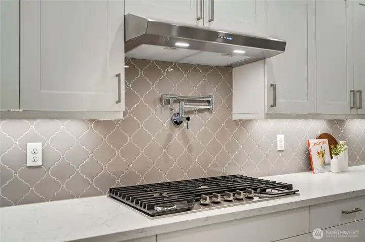 Pot filler + gas cooktop = luxury meets everyday function.
