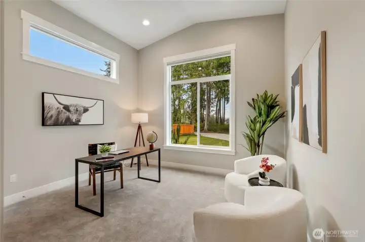 Flexible main-floor bedroom/office with large windows and peaceful treed outlook—ideal for work-from-home, guests, or multi-generational living.