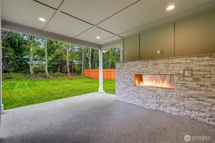 Year-round outdoor living — covered patio + cozy fireplace.  Private backyard oasis backing natural greenspace.