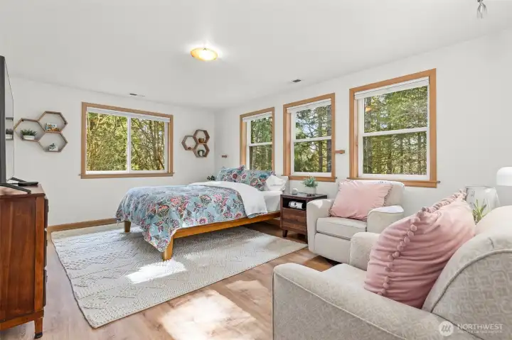 Primary bedroom is oversized and has ample room for a sitting area near the fireplace