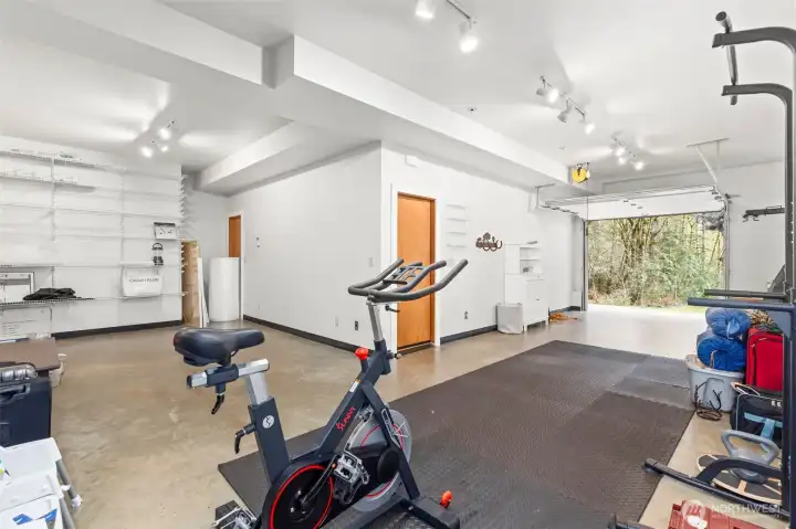 Massive lower garage with single door for an enviable shop, vehicle storage, watercraft storage, lawn equipment, crafting, or whatever else you may need it for!