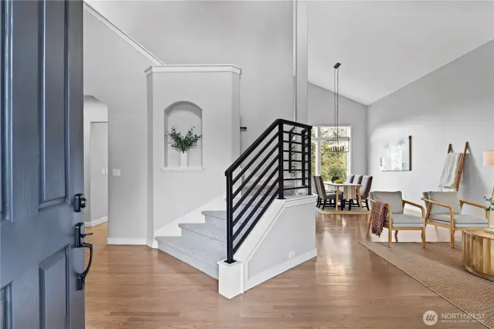 Grande entry with towering ceilings and custom stair rail