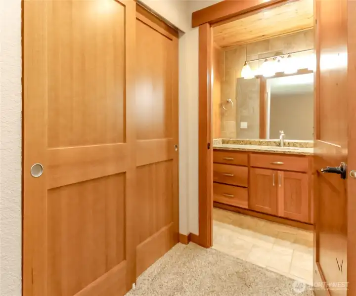 Closet and entrance to bath off of primary bedroom