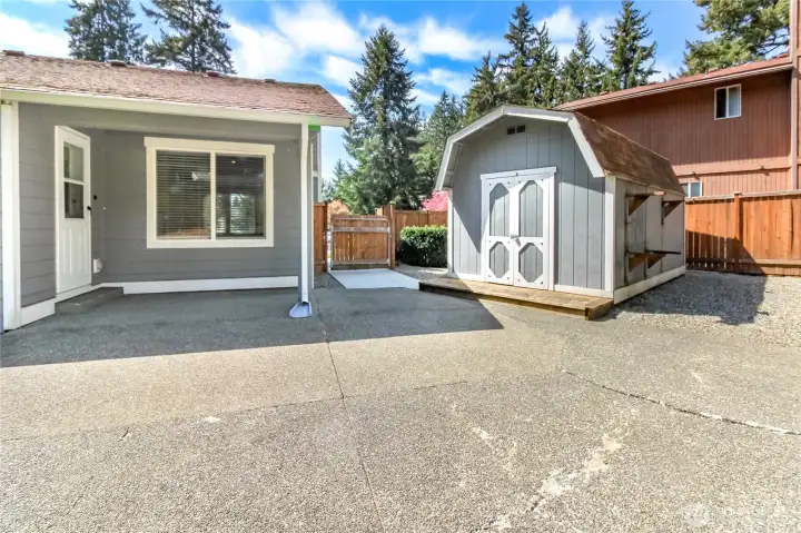 Oversized shed in back yard has work bench inside