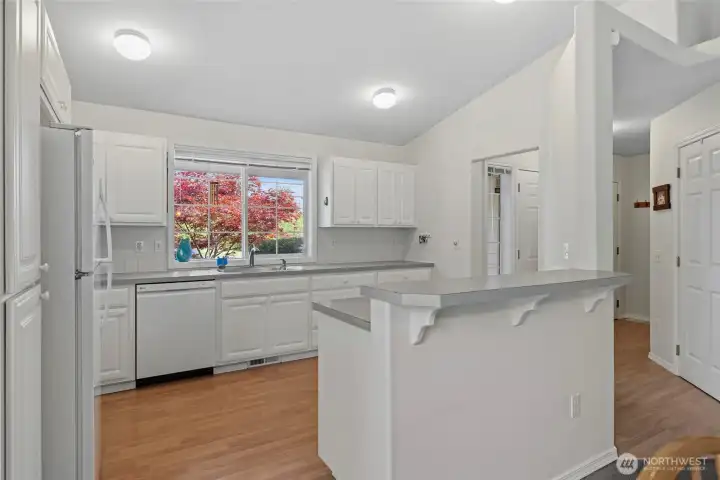 Spacious island with snack bar seating opens seamlessly to the dining and living areas, perfect for gathering and entertaining. Spacious island with snack bar seating opens seamlessly to the dining and living areas, perfect for gathering and entertaining.