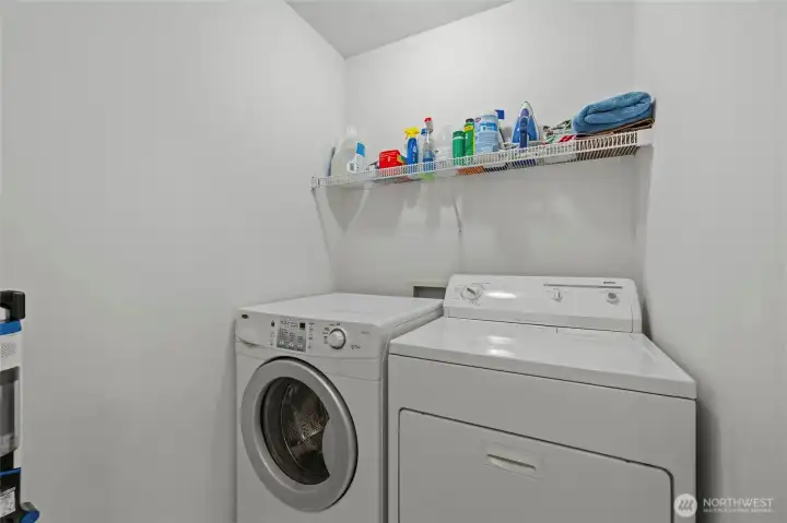 Laundry room with built-in shelving for added storage and everyday convenience. Laundry room with built-in shelving for added storage and everyday convenience.