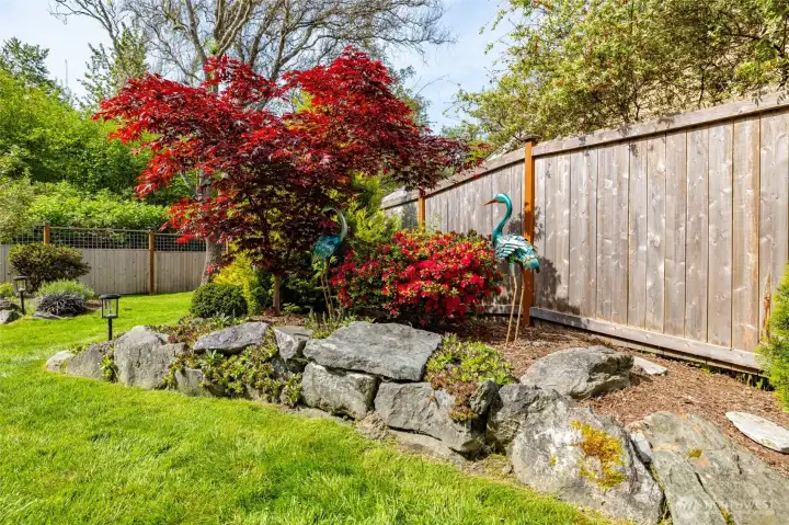 New fencing encloses a fully fenced yard, complemented by beautiful landscaping that enhances both privacy and curb appeal. New fencing encloses a fully fenced yard, complemented by beautiful landscaping that enhances both privacy and curb appeal.
