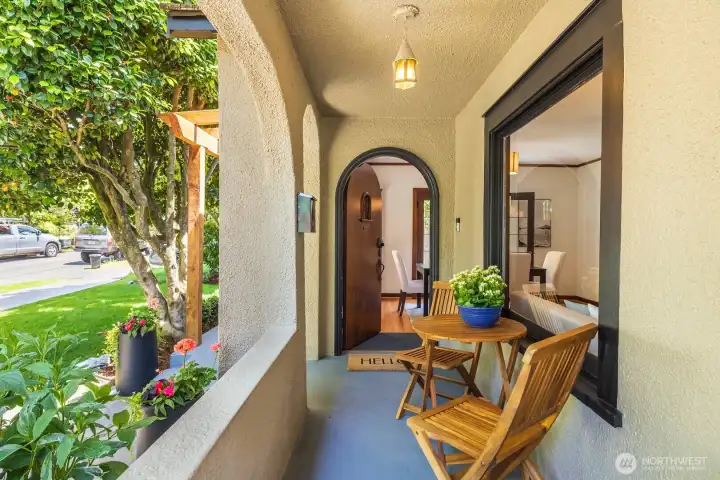 A covered porch & charming arched doorway welcome you home.