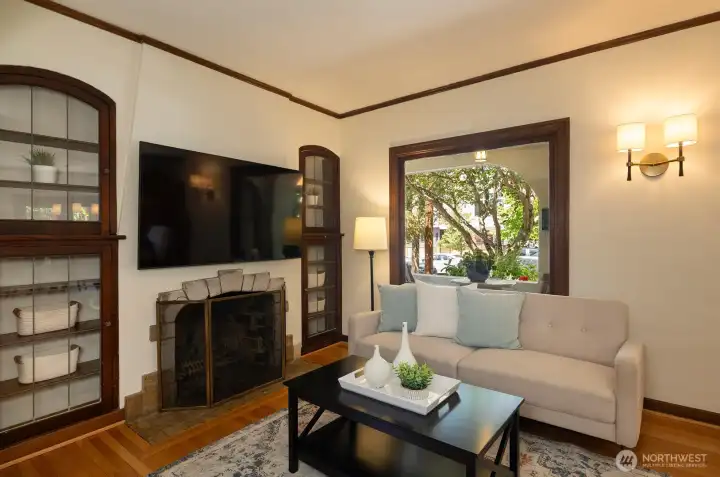 Custom built-ins flank the period fireplace.