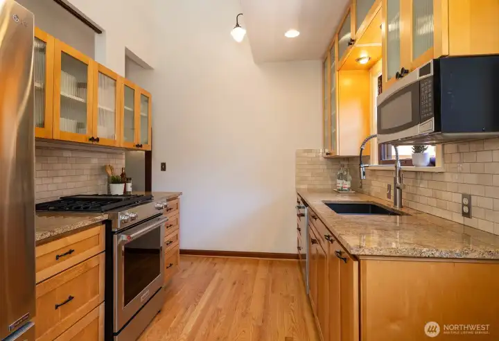 Ample cabinet space, including glass-front display cupboards.