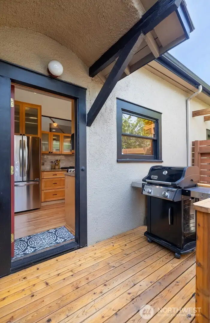 A patio door opens from the kitchen to this new deck for easy BBQ grilling.