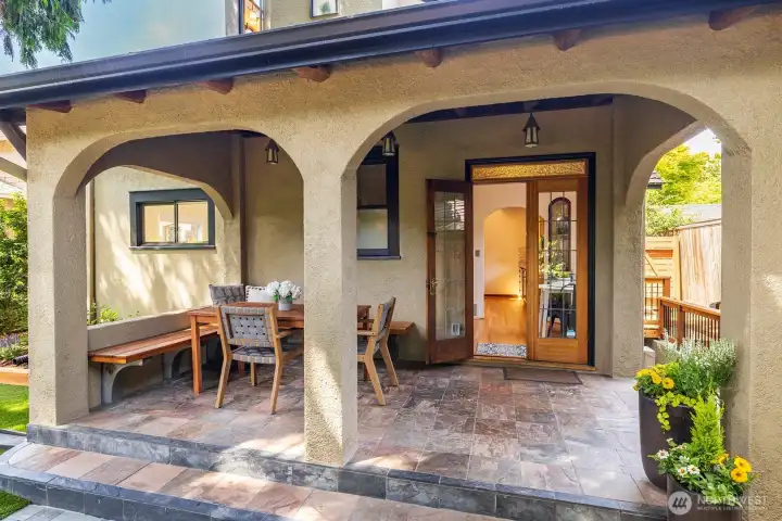 French doors open to the covered back patio with handy built-in seating.