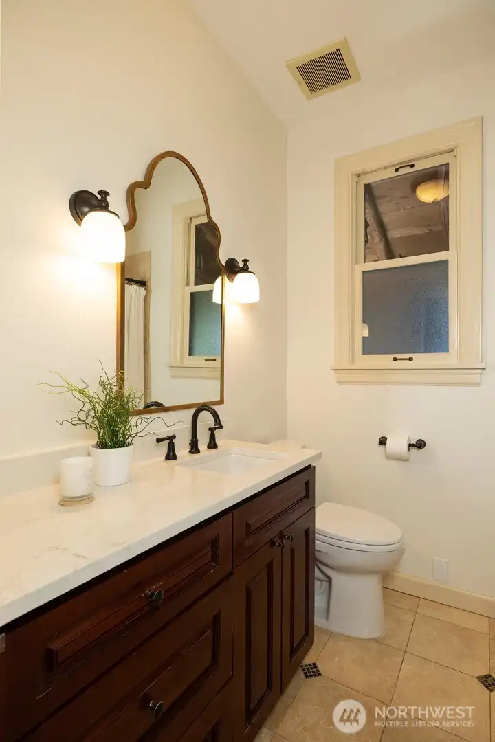 Remodeled main-floor bath features new quartz countertops.