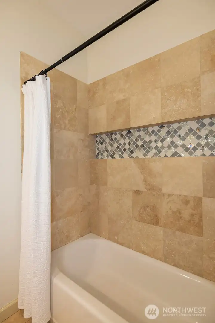 Full tile-surround bathtub in the main-floor bath.