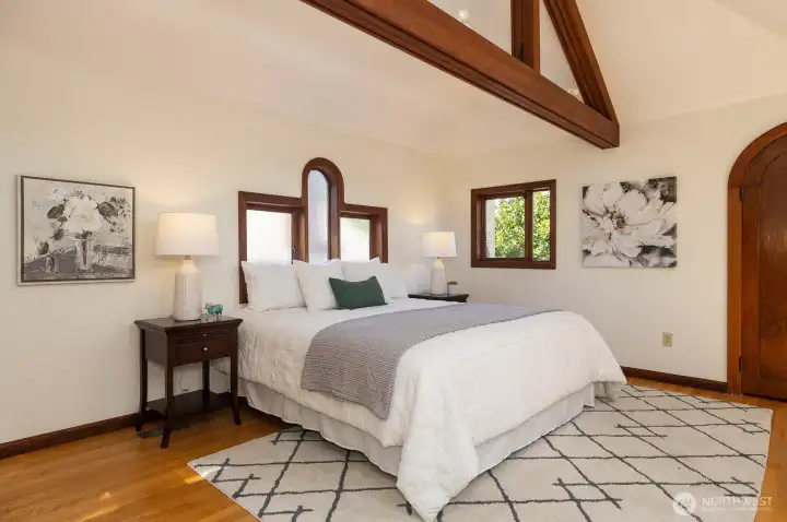 Your vaulted primary suite awaits upstairs with new windows & warm timber beams.