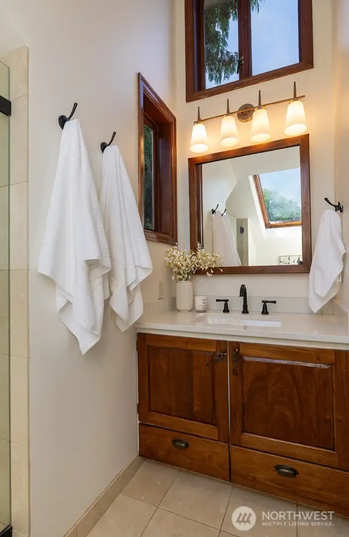 En-suite primary bath with vaulted ceiling.