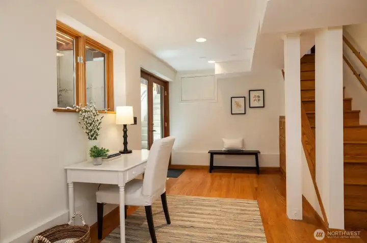 French doors & a stairway lead up to the back yard.