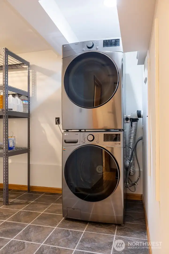 Full laundry room with plenty of extra space for storage.