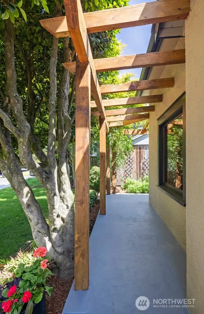 Wrap-around front patio with a lovely, wisteria-draped arbor.