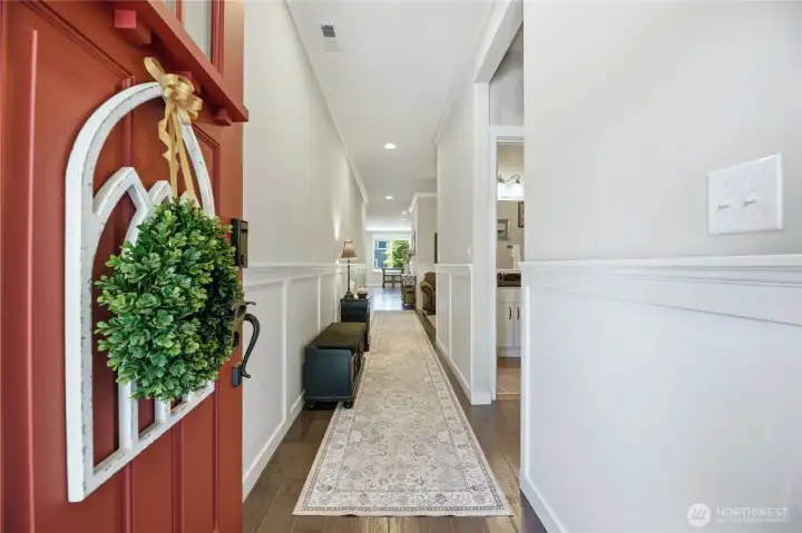 Front Door and Foyer- Crisp crown molding and classic wainscoting