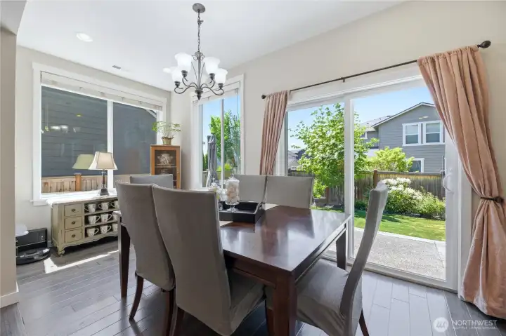 Sun-drenched sunroom that floods the entire area with natural light even on cloudy days currently used as the dining room. Look at all those windows and light!