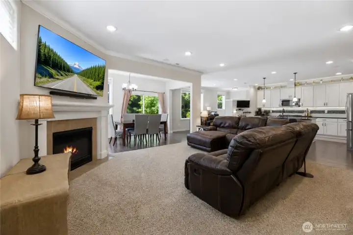 Living room picture on tv and fire in fireplace are virtually staged
