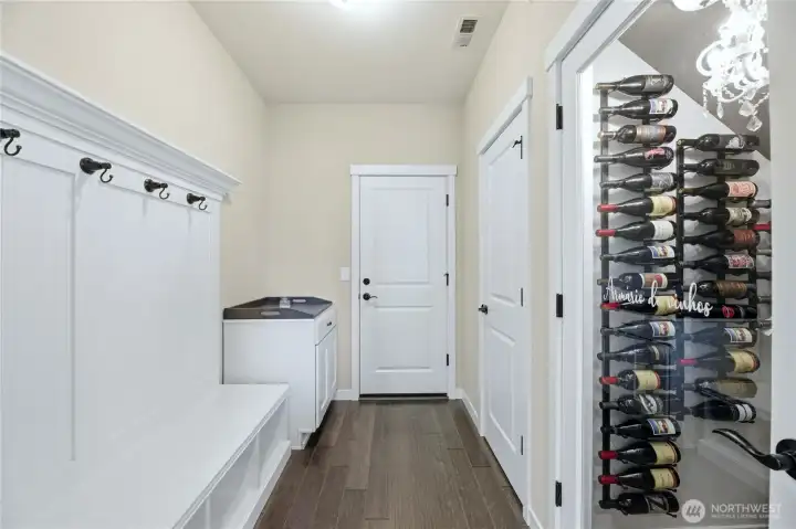 Mud Room off of the garage features a large closet and custom wine closet.