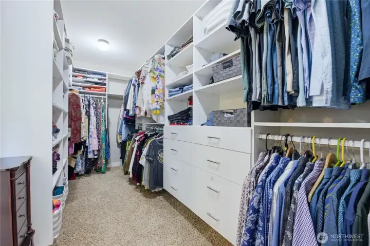 Large primary closet outfitted with premium California Closet system.