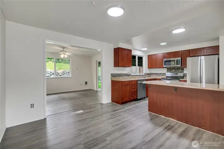 Open-Concept Kitchen! Spacious Breakfast Bar + Dining Room + easy access to large covered patio - perfect for those summer BBQs!