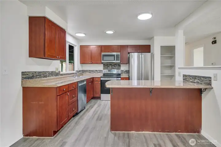 Signature tile, stone, metal, glass backsplash! Updated lighting!