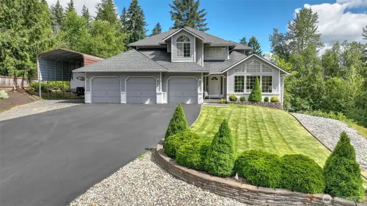 Front of home w/3 car garage, large covered RV/Boat carport. Tons of driveway parking