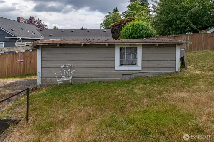 Side of garage and steps up to backyard