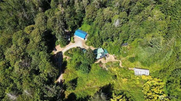This may be the property you have been waiting for. 20 acres with lush forest and trails, Large shop and off- grid cabin. Ready for you to call home or bring your plans and turn it into your dream property