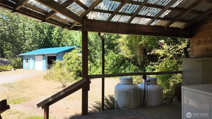 Covered patio with owned propane tanks. 3 tanks total.