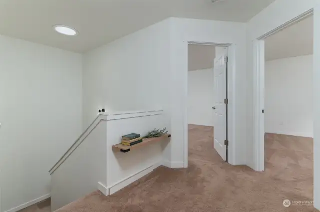 Upper stairway landing showing entry to bedrooms #2 and #3. Notice the solar light tube that helps the stairway nice and bright.