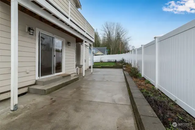 Newer back patio with sliding door leading to the kitchen and dinning room.