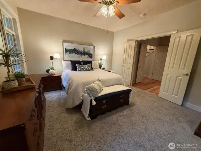 Beautiful primary bedroom w/ French doors and new carpet!