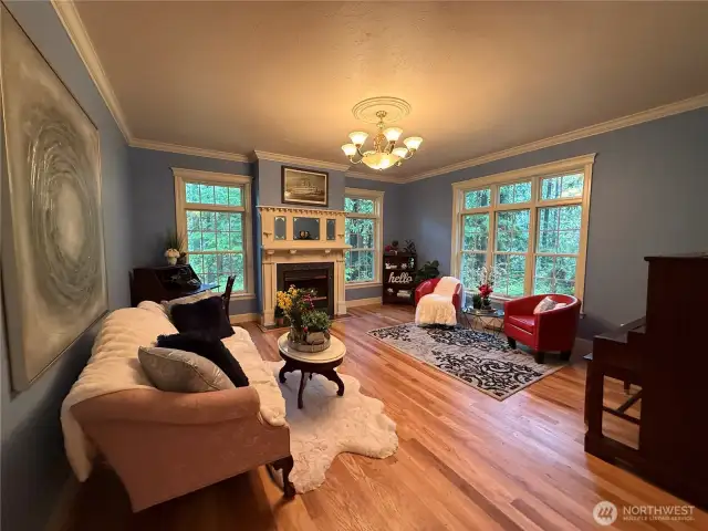 A lovely 2nd living room w/ gorgeous crown molding and beautiful gas fireplace!