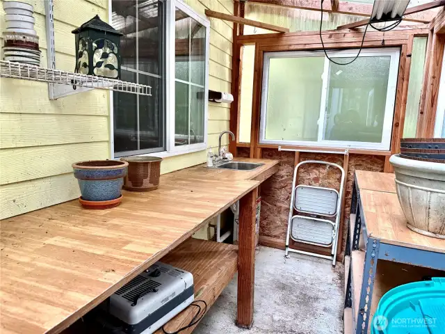 Potting room w/ bench and sink attached to shop w/ own entrance.