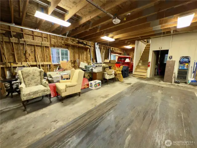 Extra large 3-car garage w/ shop, 1/2 bath and upstairs has additional space that can be finished out.