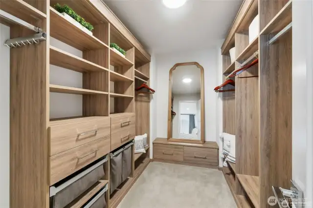 In the heart of the primary suite, a second exquisite walk-in closet awaits, a haven for the discerning homeowner's fashion treasures. Upon entering, you're greeted by an expansive space that exudes both elegance and functionality. This walk-in closet is thoughtfully designed and meticulously organized, caters to every storage need. It provides a dedicated home for folded clothing, shoes, handbags, and accessories. The shelves are a harmonious blend of form and function, offering a customizable haven for your prized possessions. The drawers are a testament to both practicality and aesthetics, perfect for stowing away smaller items like jewelry, scarves, and socks. Smooth-gliding mechanisms make accessing your treasures a breeze. The full-length mirror is framed with sophistication, it not only serves as a reflection of your style but also adds a touch of luxury to the closet's ambiance, creating a space where every outfit becomes a statement. Overhead lighting casts a warm and in...