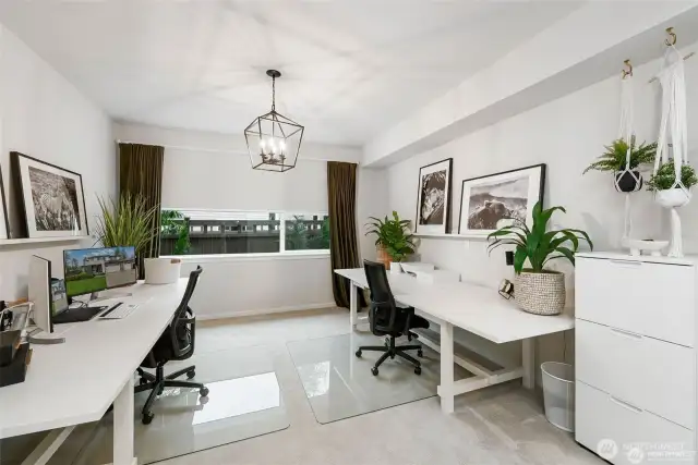 Step inside and prepare to be captivated by an another area of the home that is nothing short of extraordinary. This stunning space has been meticulously designed to create the perfect setting for hosting unforgettable gatherings and lavish soirées. Step into the realm of elegance as you explore this extra finished room, a versatile space that is currently being utilized as a two-person office. From the moment you cross the threshold, you'll be captivated by the sophisticated atmosphere that envelops you. Natural light streams in through the large windows, casting a gentle, flattering glow that enhances the room's graceful ambiance. Elegant curtains frame these windows, offering both privacy and an added touch of luxury. The lighting fixture in this room is a true testament to its elegance. This extra finished room is a testament to the exquisite taste of its current occupants, who have created a space that effortlessly balances functionality and elegance....